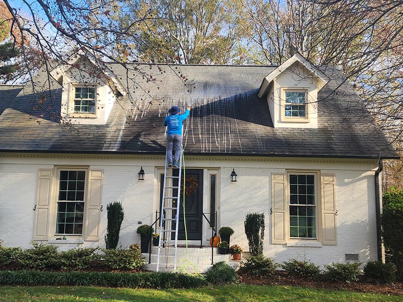 removing black algae stains on roofs by Bluewhale Powerwash in Charlotte